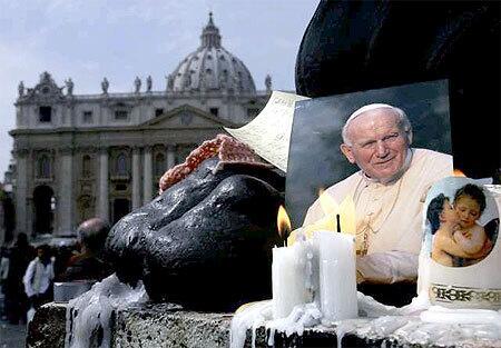 A photograph of Pope John Paul II is part of a makeshift memorial to the pontiff in St. Peter's Square.