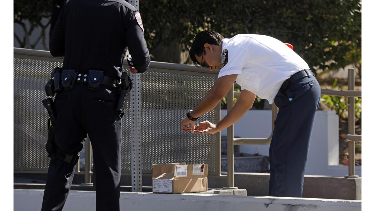 Police and fire officials investigate suspicious envelopes at the Los Angeles Times building on East Imperial Highway in El Segundo.