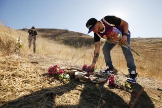 CALABASAS, CA - JANUARY 26: Anthony Calderon, 33, from West Hills brought flowers and arranged rocks in a figure 8 on the mountainside in Calabasas where a helicopter crashed one year ago killing Kobe Bryant, his daughter Gianna, and seven others. Several fans of Kobe found ways to hike to the location Tuesday morning on the one year anniversary. Calabasas on Tuesday, Jan. 26, 2021 in Calabasas, CA. (Al Seib / Los Angeles Times)