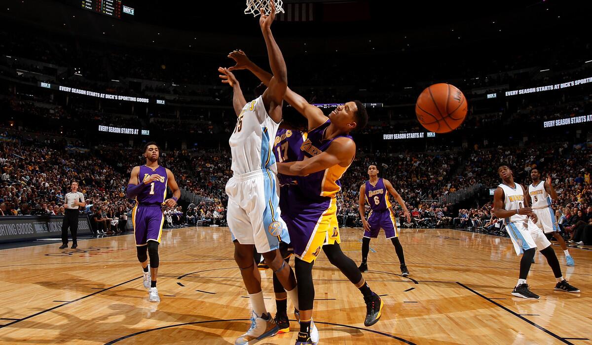 Lakers' Anthony Brown, right, commits a foul type against Denver Nuggets' Kenneth Faried in the second quarter on Wednesday.