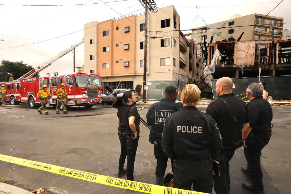 Members of the LAFD arson team and LAPD investigate a fire in Chinatown.