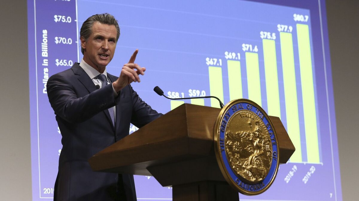 California Gov. Gavin Newsom presents his first state budget during a news conference in Sacramento.