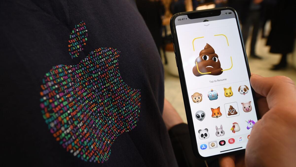 Emojis are shown on an Apple iPhone X.
