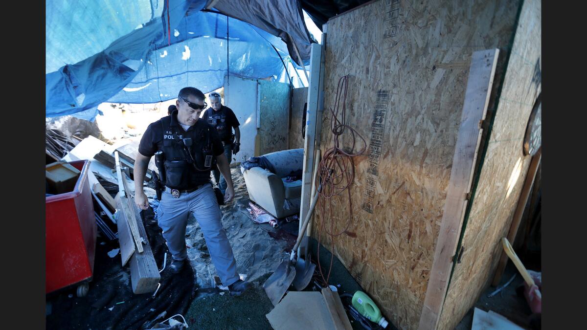 Officers from the Orange County Sheriff's Department and the Anaheim, Orange and Fountain Valley police departments have been clearing out homeless camps along the Santa Ana River trail.