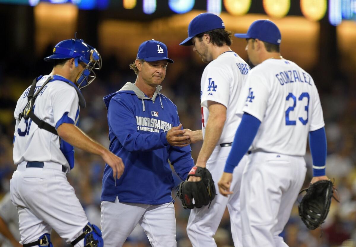 Dodgers Manager Don Mattingly takes Dan Haren out of the game in the fifth inning. Haren (8-6) was charged with four runs on six hits over four innings.