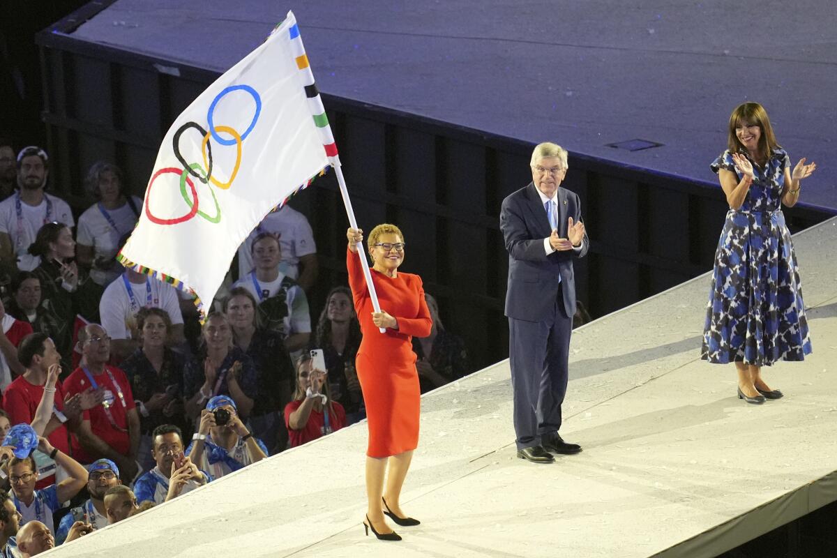 Los Angeles Mayor Karen Bass, left, holds 