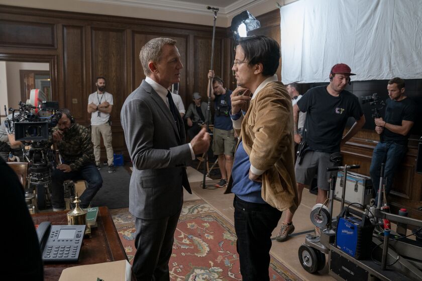 Daniel Craig (James Bond) and director Cary Joji Fukunaga on the set of 'No Time To Die.'
