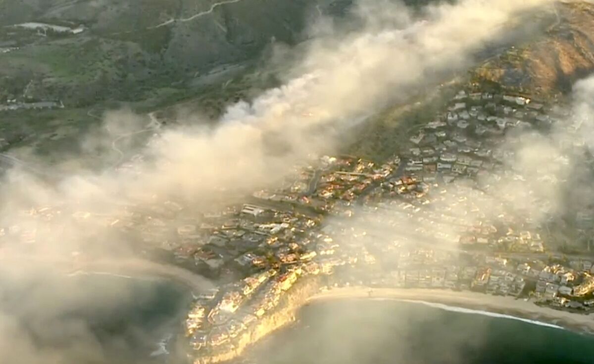 An aerial view of a neighborhood and smoke.