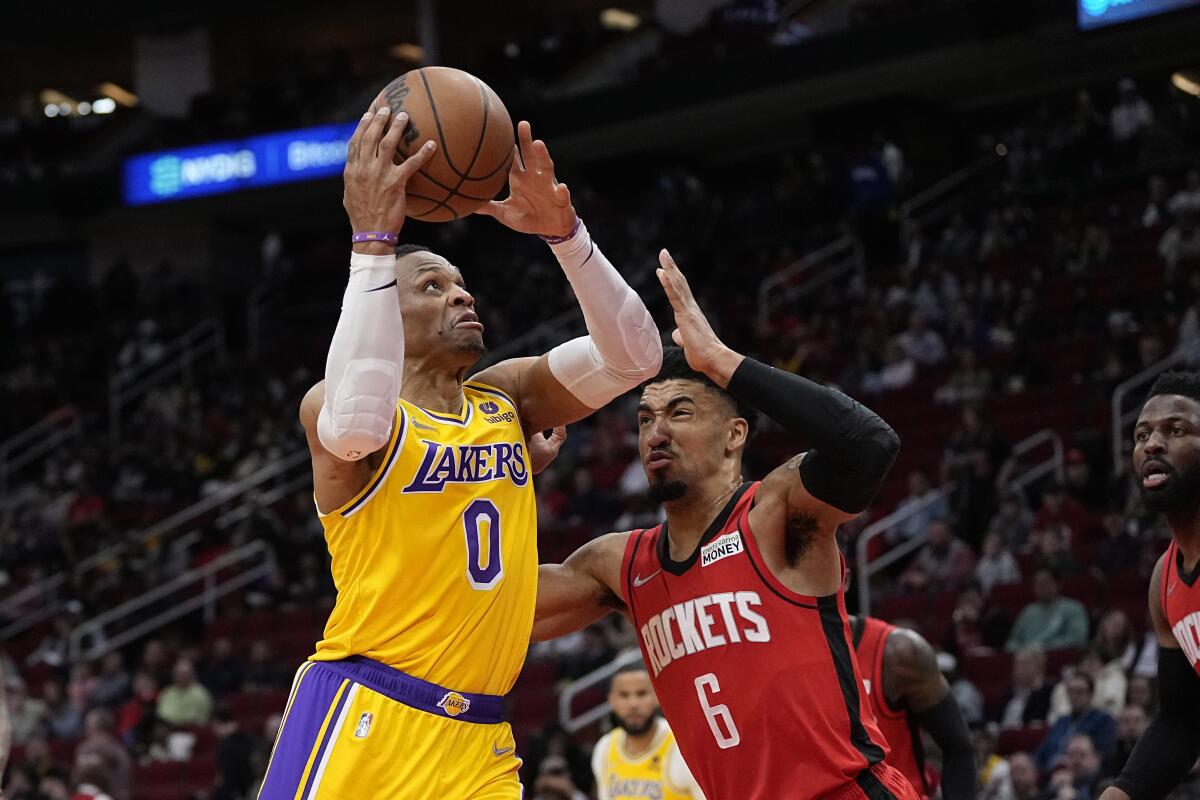 Lakers' Russell Westbrook goes up for a shot as Houston Rockets' KJ Martin Jr. defends.