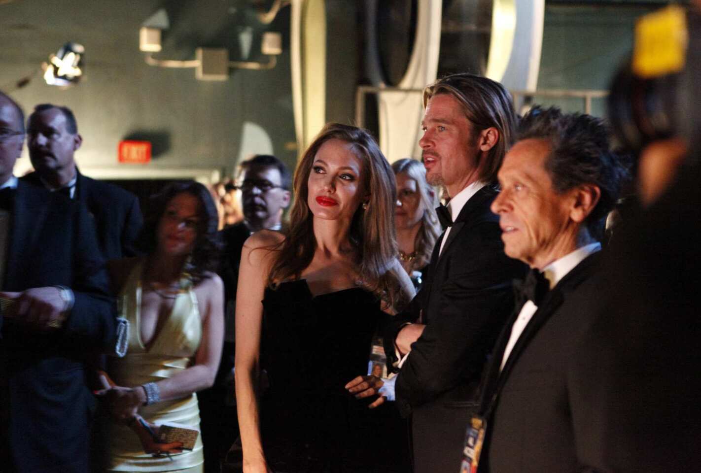 The powerhouse couple watch the show off-stage with the Academy Awards producer. Pitt was nominated Sunday night for his role in 'Moneyball."