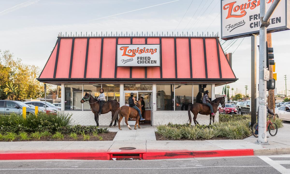 Members of the Compton Cowboys wait outside a restaurant in Compton.