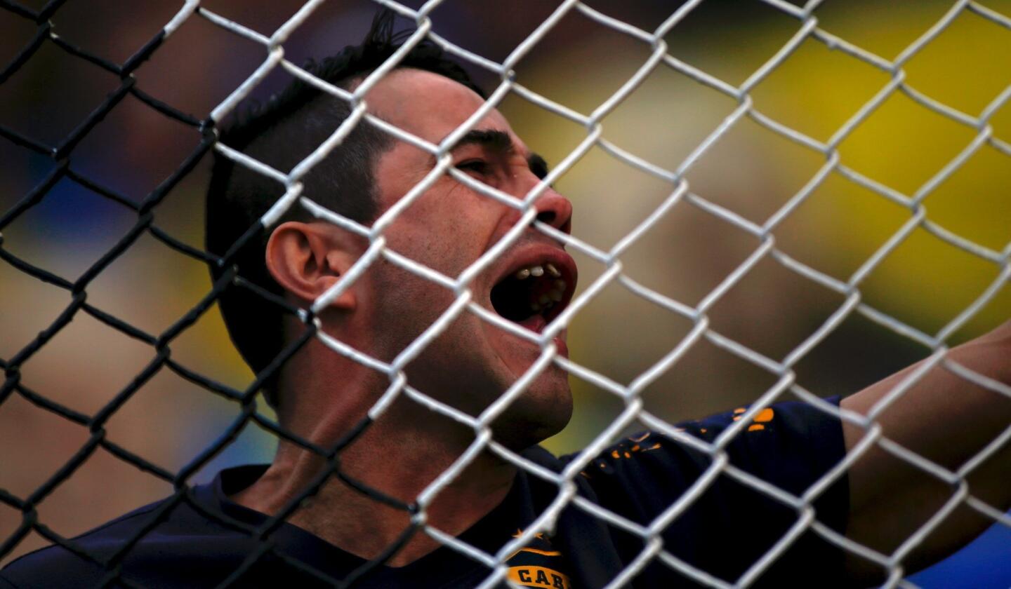 A fan of Boca Juniors cheers his team on during their Argentine First Division soccer match against Tigre in Buenos Aires