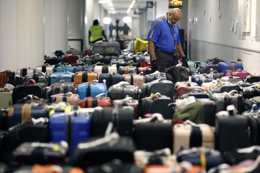 Rows of luggage wait for their owners in the Southwest Airlines baggage claim at LAX on Thursday.