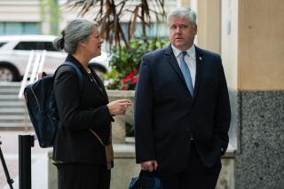 two people arrive at a U.S. Courthouse