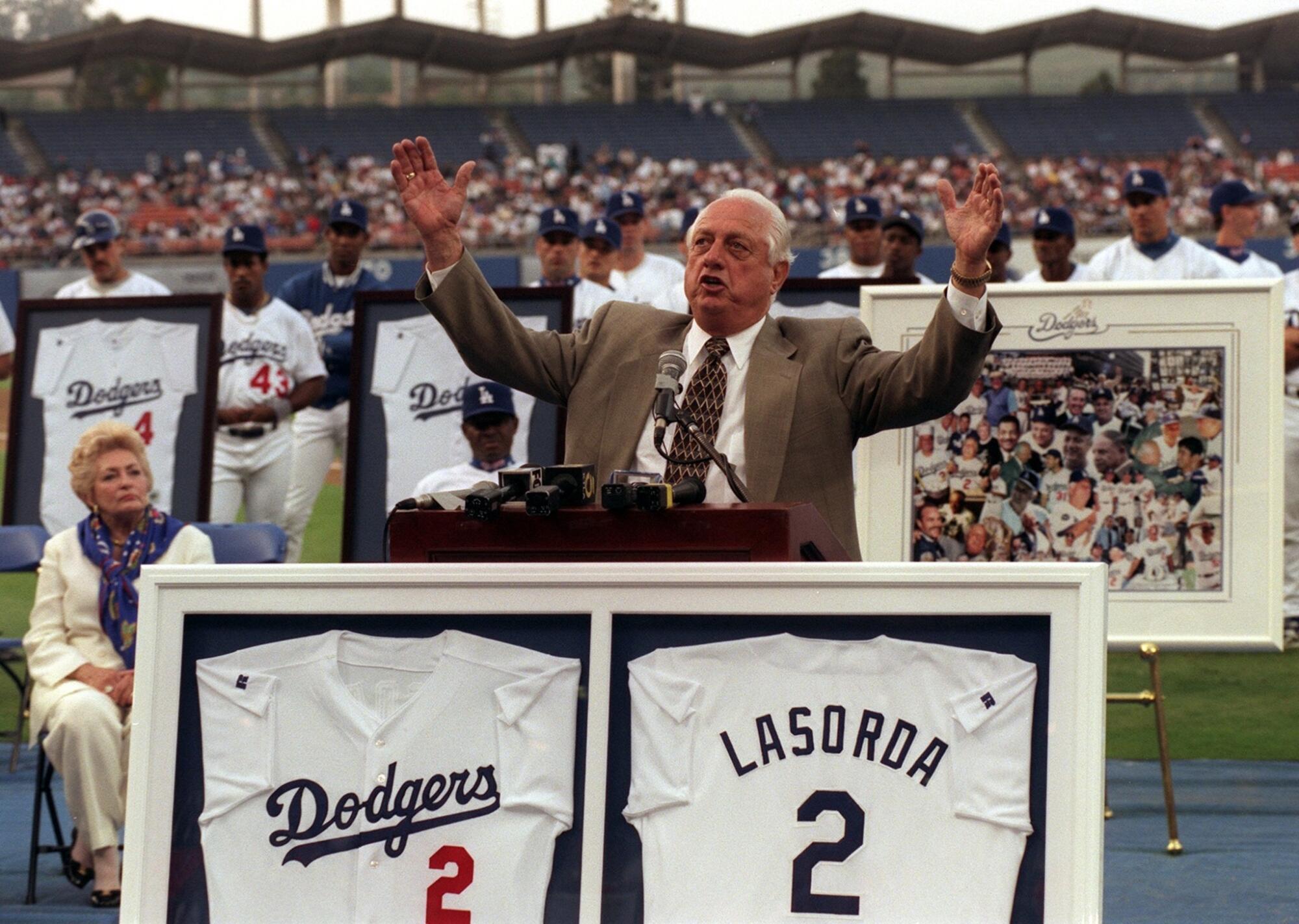 Tommy Lasorda acknowledges the crowd at Dodger Stadium as his number is retired in 1997