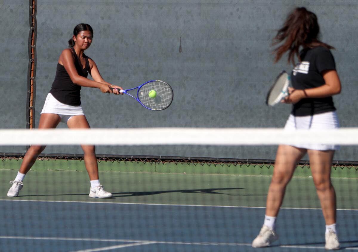 Glendale High School tennis doubles player Janet Louie returns the ball in away game vs. Crescenta Valley High School, in La Crescenta on Tuesday, Oct. 22, 2019.