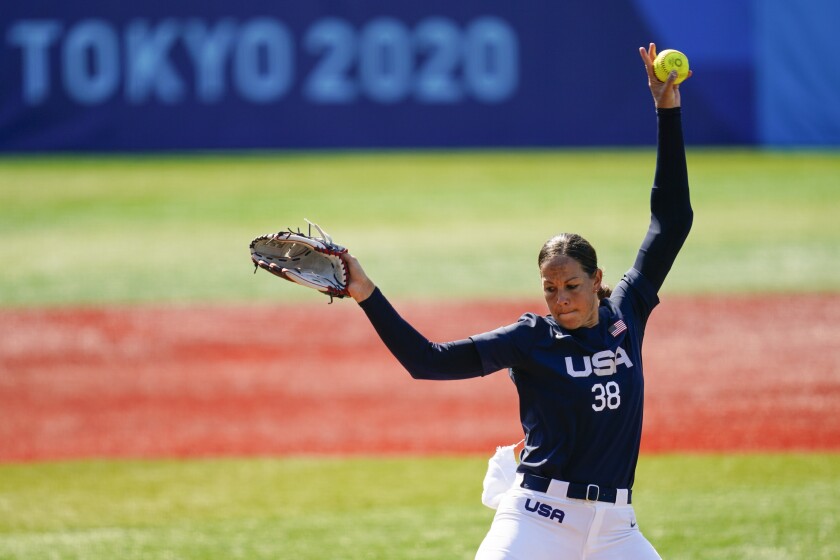 Cat Osterman, in the circle, delivers a pitch.