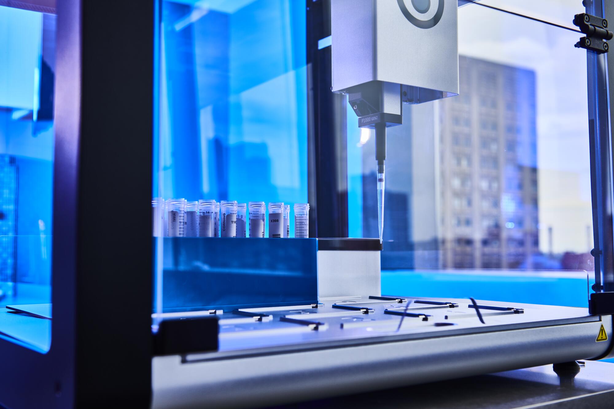 A machine with a penlike tapered tip and test tubes in the back