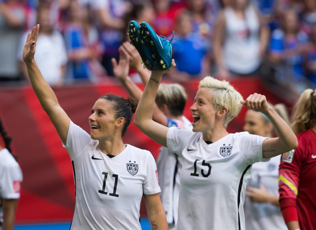 The United States' Ali Krieger and Megan Rapinoe, right, aknowledge the crowd after their 1-0 win over Nigeria during the group stage of the Women's World Cup in Vancouver, Canada.