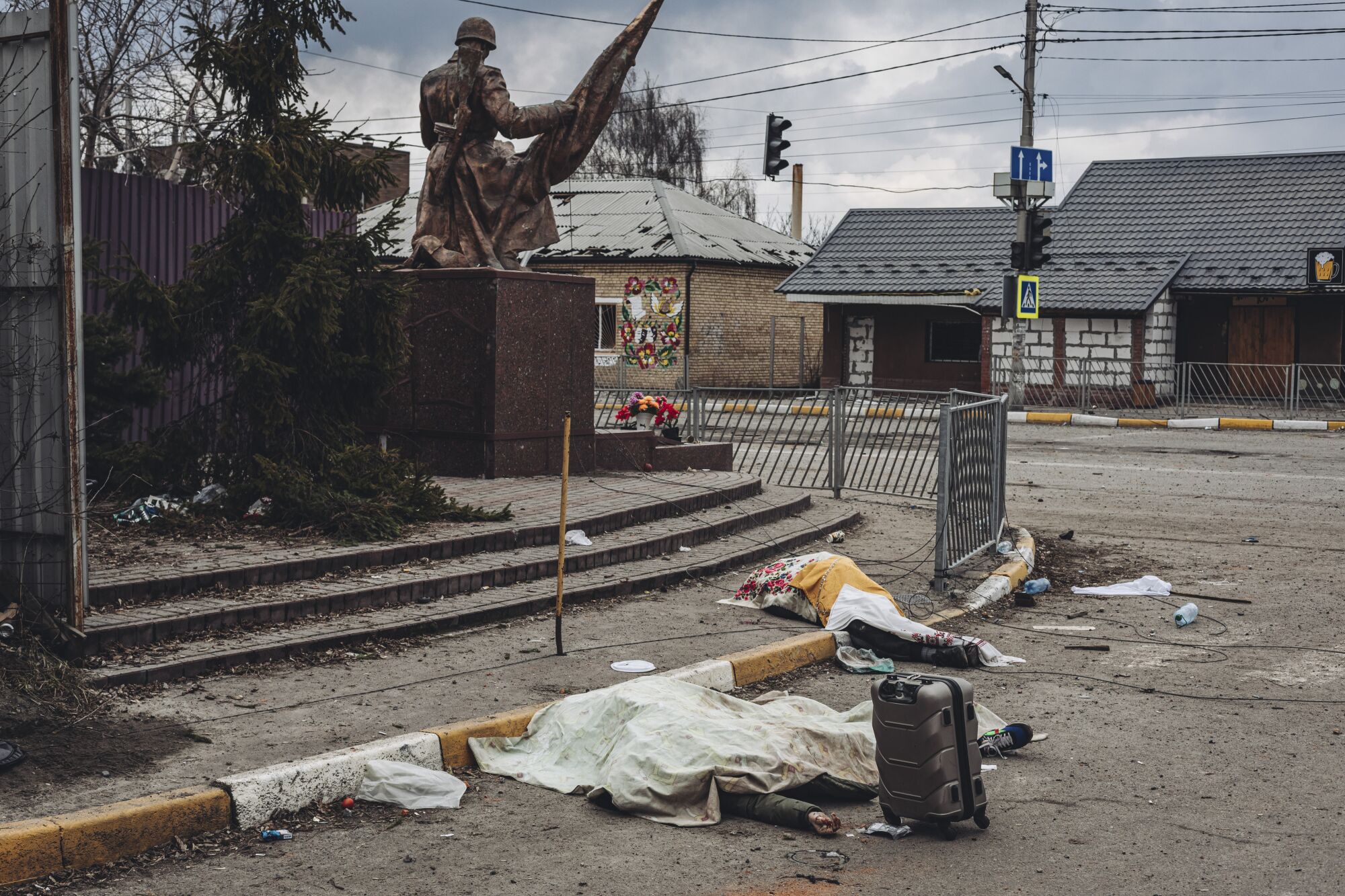 The dead bodies of people killed by Russian shelling lay covered in the street in the town of Irpin, Ukraine.