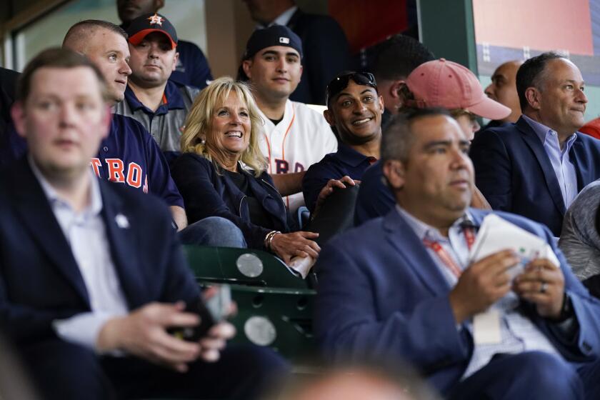 FILE - In this June 29, 2021, file photo first lady Jill Biden and Doug Emhoff sit with military members and first responders as they attend a baseball game between the Houston Astros and the Baltimore Orioles at Minute Maid Park, in Houston. (AP Photo/Carolyn Kaster, Pool, File)