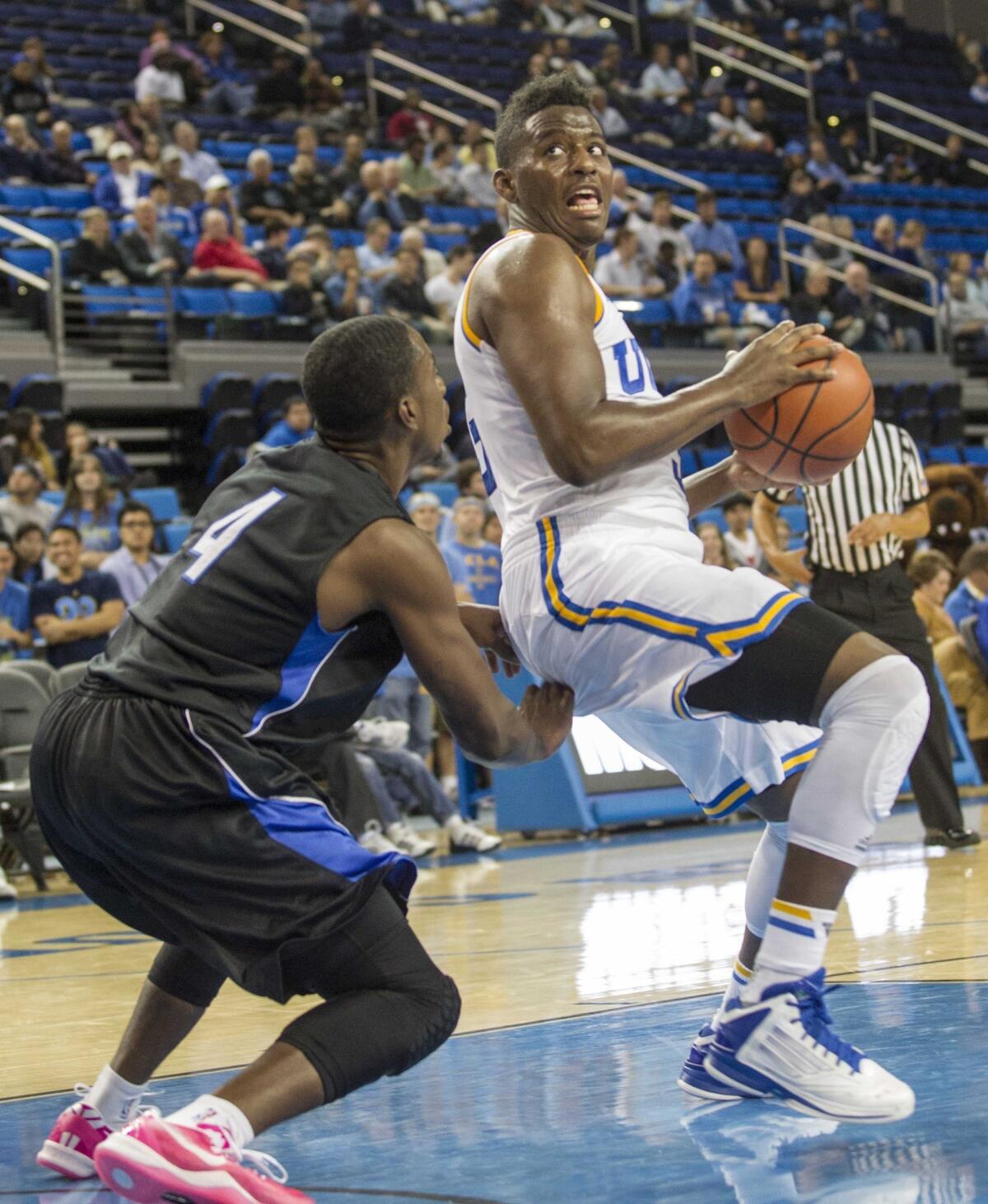 UCLA's Jordan Adams, right, drives to make his way past Cal State San Bernardino's Larry Thompkins III during a preseason game last month. Adams is glad the hype that surrounded last year's freshman class has died down.