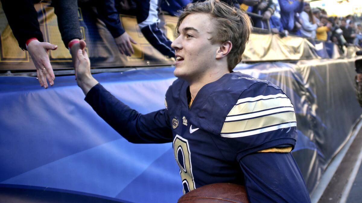 Pittsburgh quarterback Kenny Pickett receives congratulations from fans after the Panthers upset No. 2 Miami on Friday.