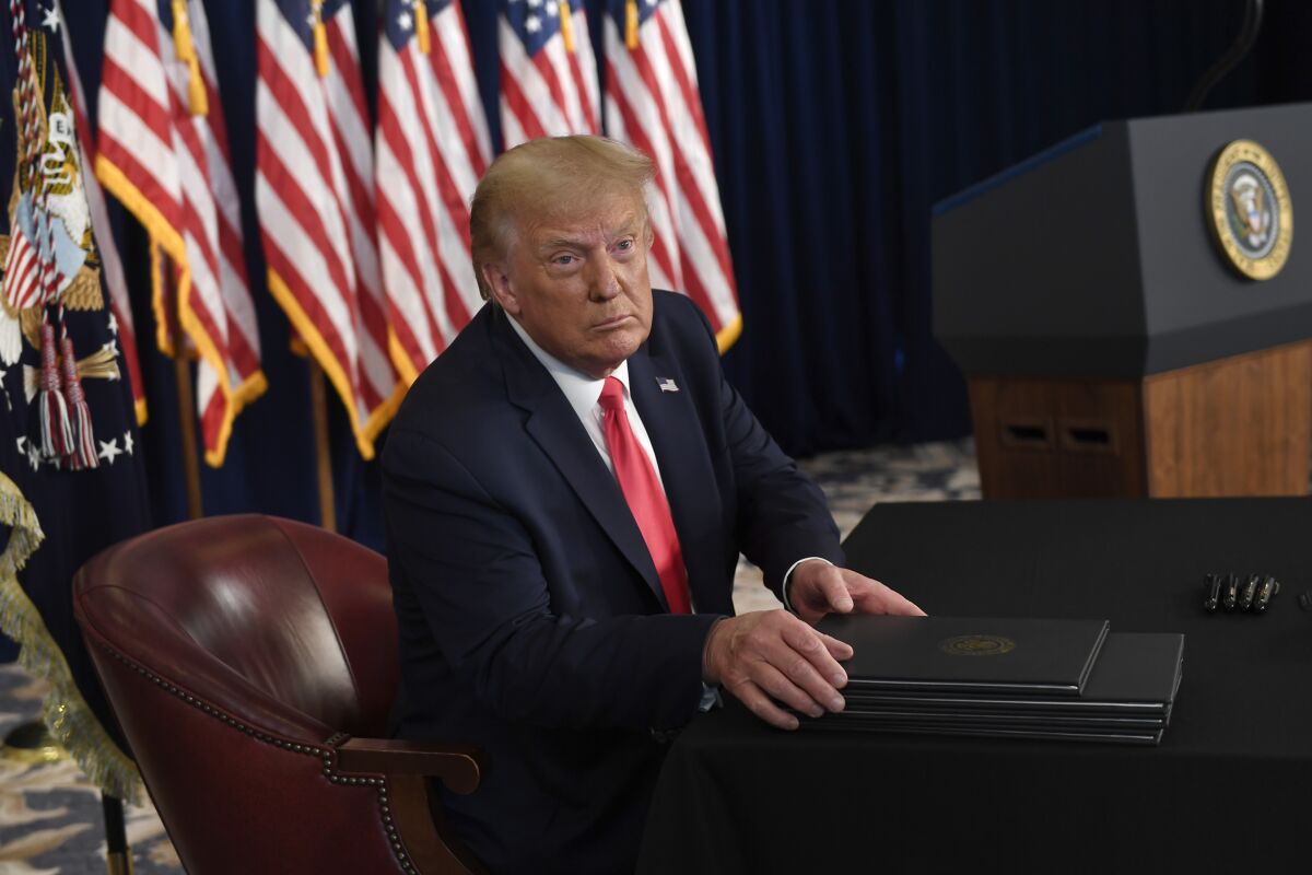 President Donald Trump prepares to sign four executive orders Saturday