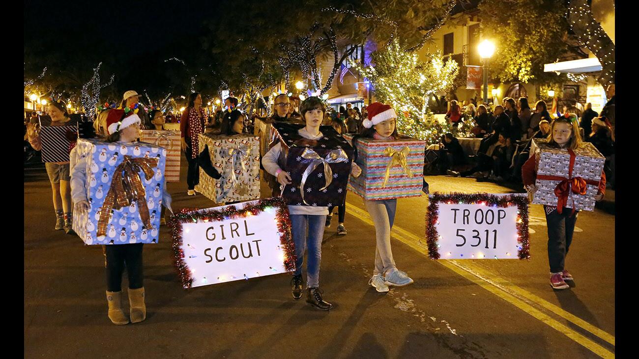 Looking like Christmas presents are members of the Girl Scout Troop 5311 marching down Honolulu Ave. for the annual Montrose Glendale Christmas Parade, in Montrose on Saturday, Dec. 2, 2017.