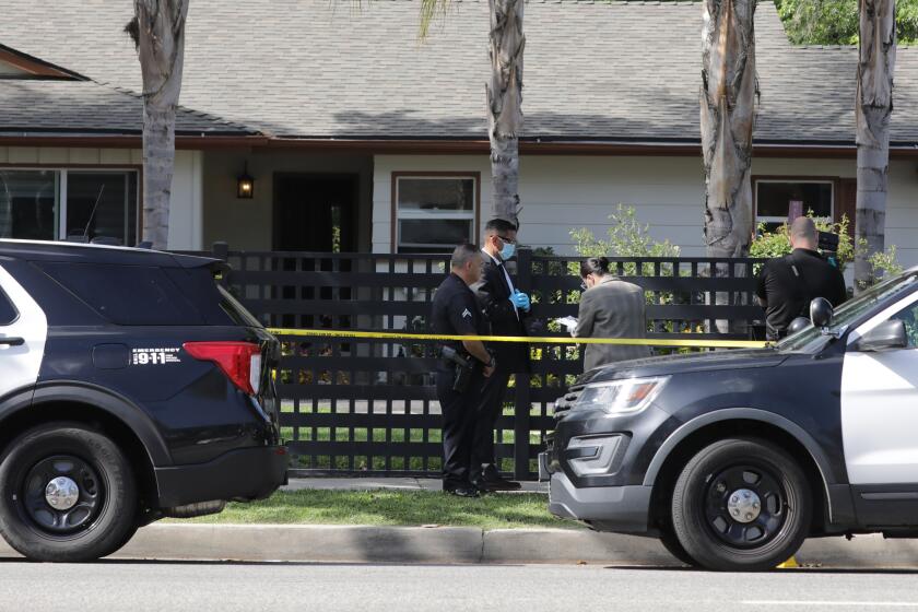 Los Angeles, CA - May 09: Law enforcement personnel investigate the scene where three children were found dead at a residence after police responded to assault with deadly weapon call on Monday, May 9, 2022 in Los Angeles, CA. (Myung J. Chun / Los Angeles Times)