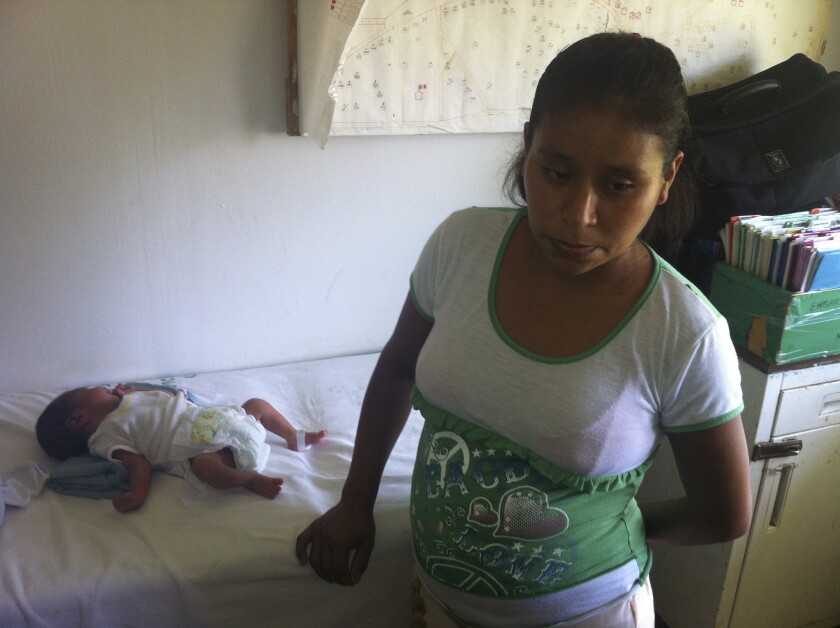Irma Lopez, 29, with her newborn son, Salvador, at a clinic in Jalapa de Diaz, Mexico. Mexican officials suspended two hospital directors after Lopez, an indigenous woman, was denied entry and was forced to give birth on the lawn.