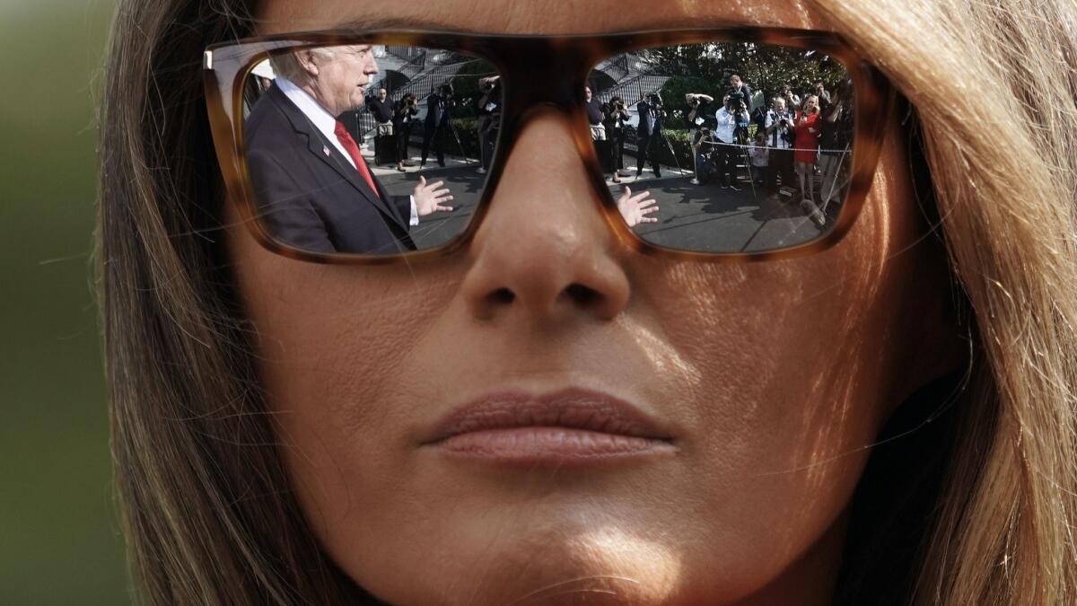 President Trump's reflection is seen in First Lady Melania Trump's sunglasses.