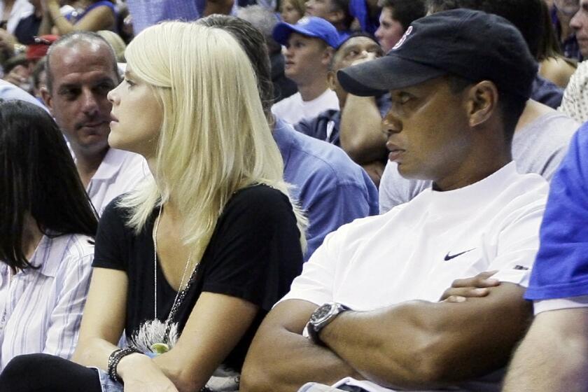 On June 11, 2009, Tiger Woods and his wife, Elin Nordegren watch the fourth quarter of Game 4 of the NBA basketball finals