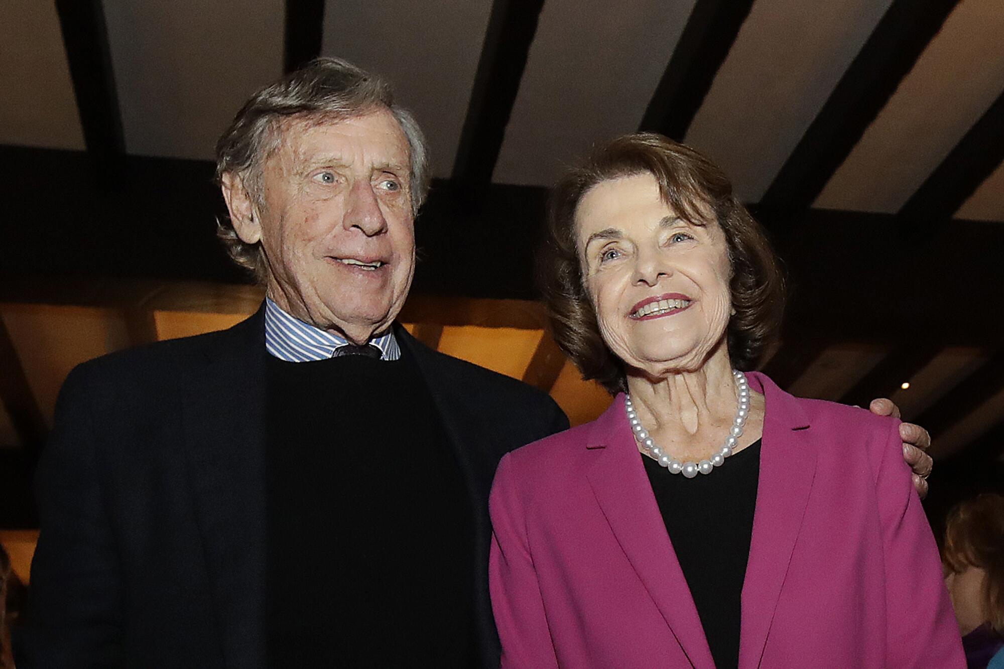Sen. Dianne Feinstein and husband Richard Blum smiling, his arm around her shoulders