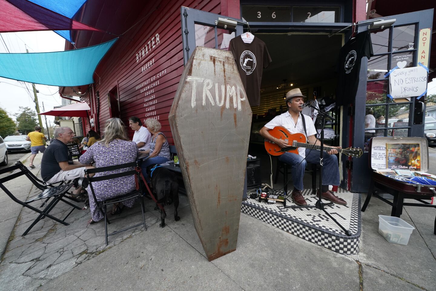 Folk musician Ted Hefko performs next to a mock casket with the name Trump written on it in New Orleans.
