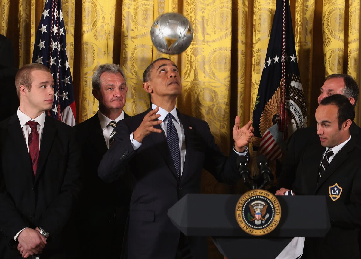 U.S. President Barack Obama bounces a soccer ball off his head when both the Kings and Galaxy visited the White House in 2013 following championships.