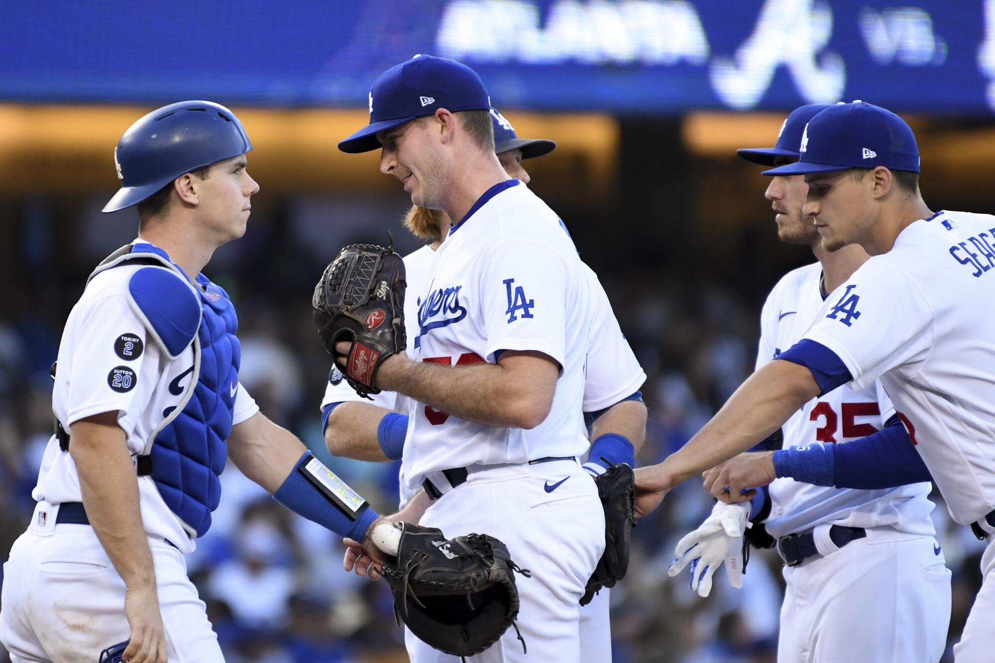 Dodgers catcher Will Smith, left, congratulates reliever Evan Phillips after a successful outing.