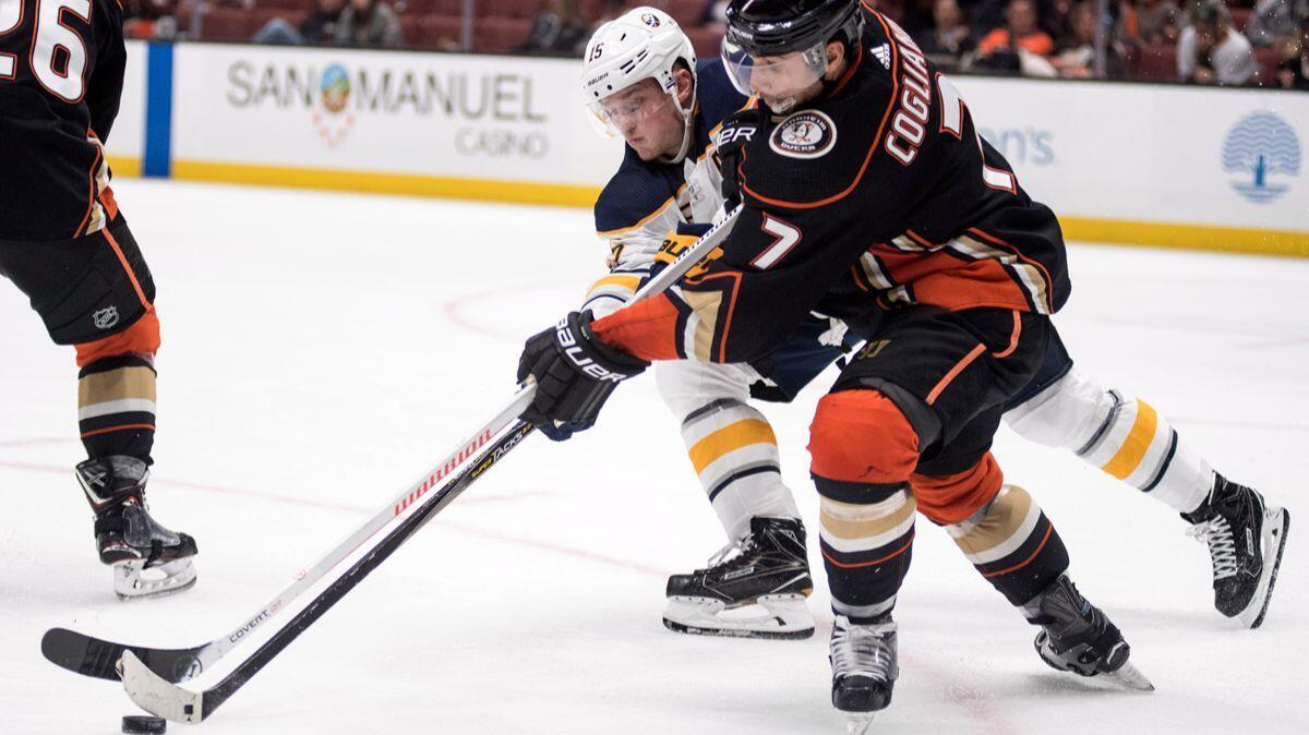 Anaheim Ducks left wing Andrew Cogliano, right, and Buffalo Sabres center Jack Eichel battle for the puck during the third period on Sunday.