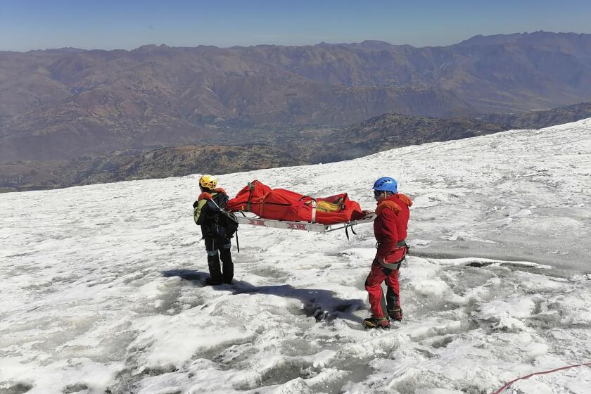This photo distributed by the Peruvian National Police shows police carrying a body that they identify as U.S. mountain climber William Stampfl, on Huascaran mountain in Huaraz, Peru, July 5, 2024. Peruvian authorities announced on Tuesday, July 9, 2024, that they have found the mummified body of the American man who died 22 years ago, along with two other American climbers, after the three were trapped in an avalanche while trying to climb Peru's highest mountain. (Peruvian National Police via AP)