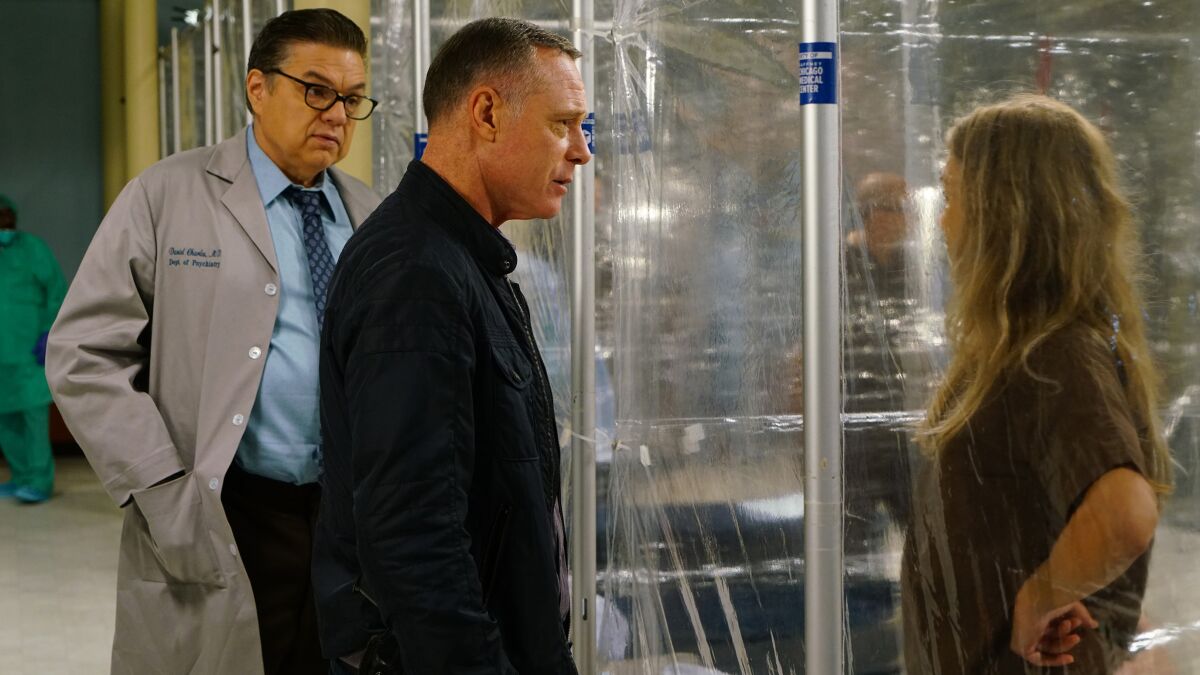 Oliver Platt, left, Jason Beghe and Tracy Spiridakos in the "Chicago Med" segment of a three-series crossover on NBC.