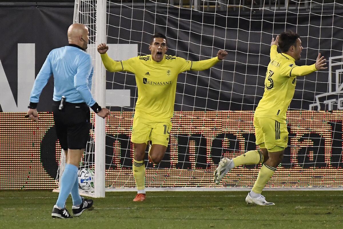 Nashville's Daniel Ríos, center, celebrates his overtime goal with teammate Taylor Washington.