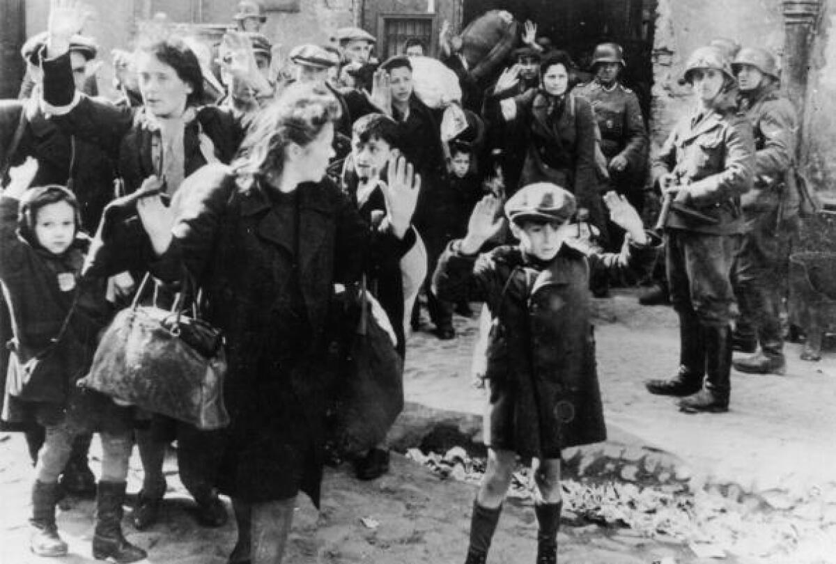 Jews from the Warsaw ghetto surrender to German soldiers