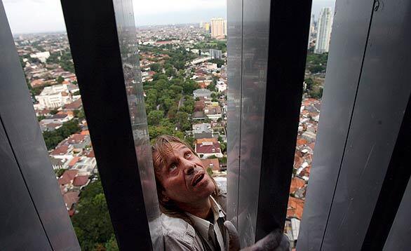 Professional climber Alain Robert scales the facade of the City Tower in Jakarta, Indonesia. The Frenchman has climbed 70 giant structures across the globe, including the Empire State Building, the Eiffel Tower, the Petronas Twin Towers in Kuala Lumpur, Malaysia, and the Sydney Opera House in Australia.