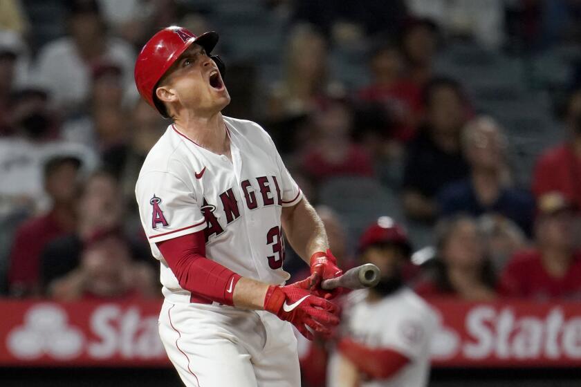 Los Angeles Angels' Max Stassi reacts as he pops out with two men on base during the seventh inning of a baseball game against the Texas Rangers Monday, Sept. 6, 2021, in Anaheim, Calif. (AP Photo/Marcio Jose Sanchez)