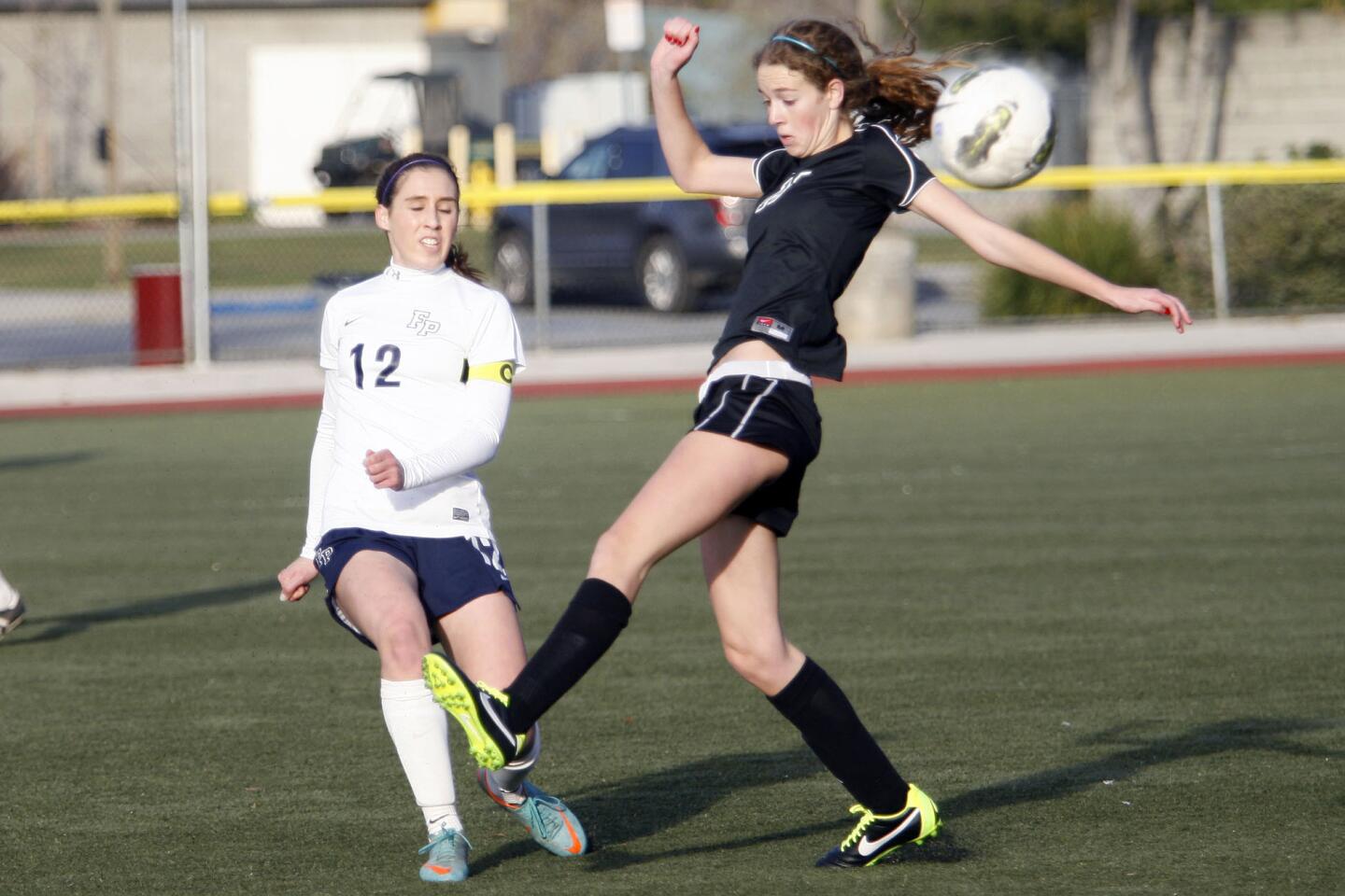 Flintridge Prep's Whitney Cohen, left, and Westridge's Julia Matthiessen fight for the ball during a game at the Glendale Sports Complex on Tuesday, January 29, 2013.