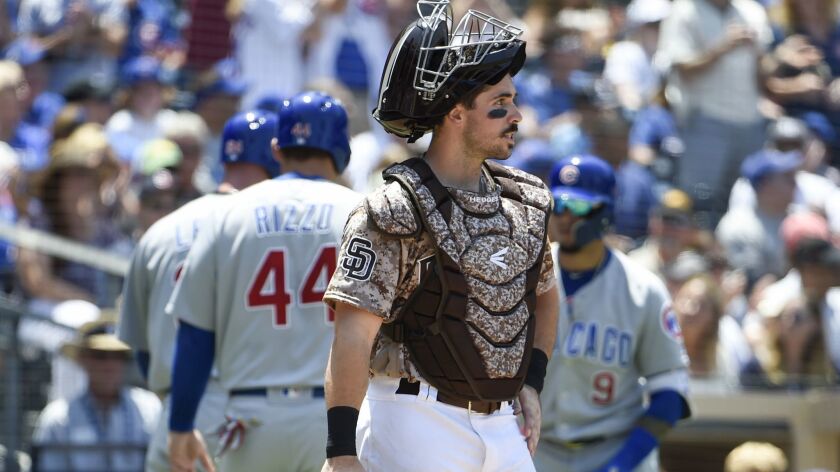 Austin Hedges looks onto the field after the Cubs score two runs in the second inning of Sunday's game at Petco Park.