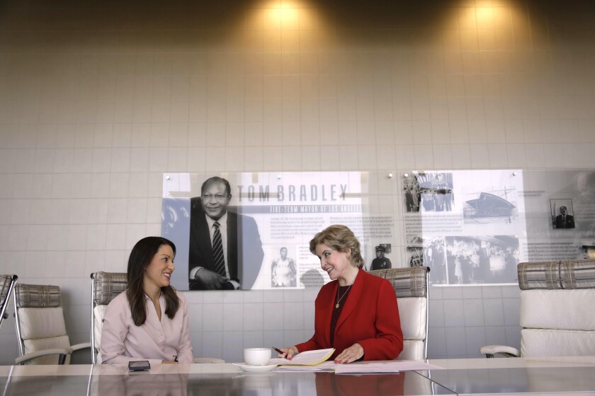 Betsy Berkhemer-Credaire and Heather Spilsbury sit in the Tom Bradley Conference Room at City Club LA. 