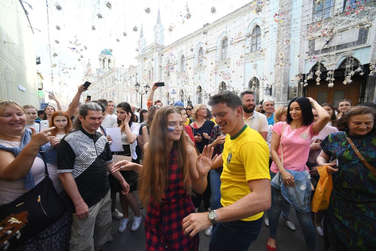 Soccer fans cheer in Nikolskaya Street near Red Square in Moscow, on June 25, 2018.