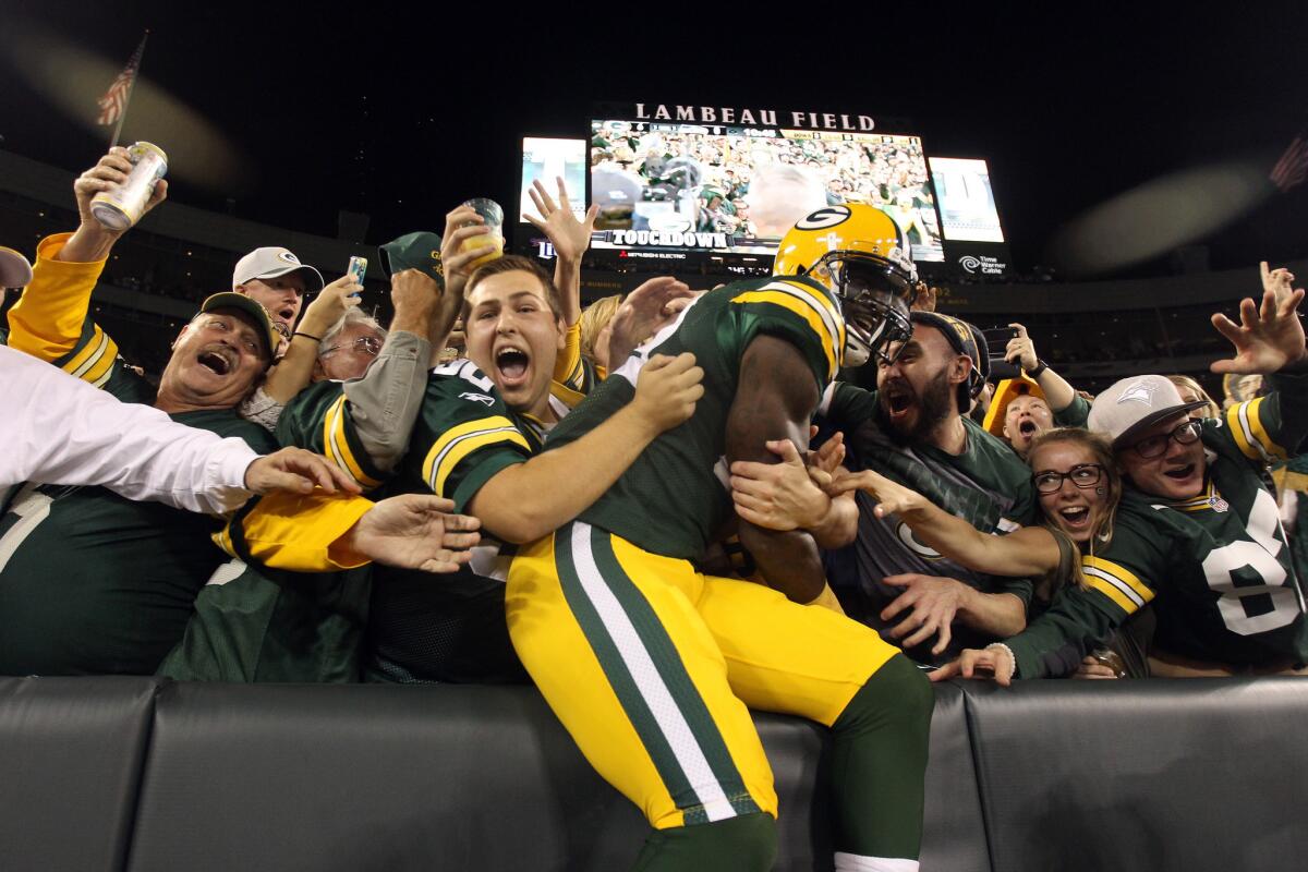 Packers receiver James Jones celebrates with fans after scoring a touchdown thrown by Aaron Rodgers. Green Bay beat Seattle, 27-17.