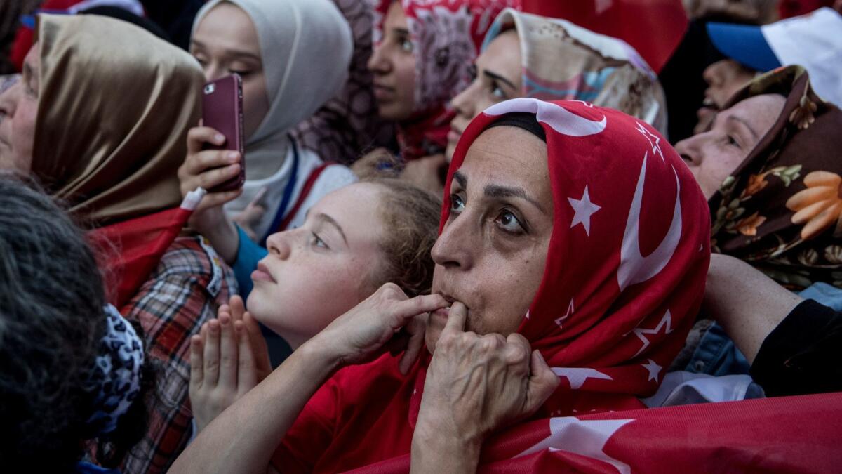 Supporters whistle and cheer as they listen to Turkey's President Recep Tayyip Erdogan speak during a rally on Friday in Istanbul.